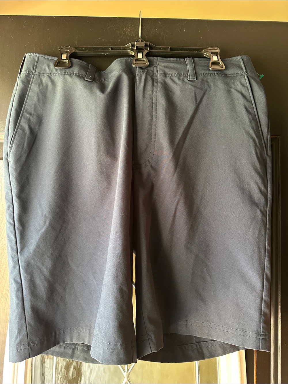 Size 34 Ben Hogan Men's Navy Flat-Front Shorts with front and back pockets.
